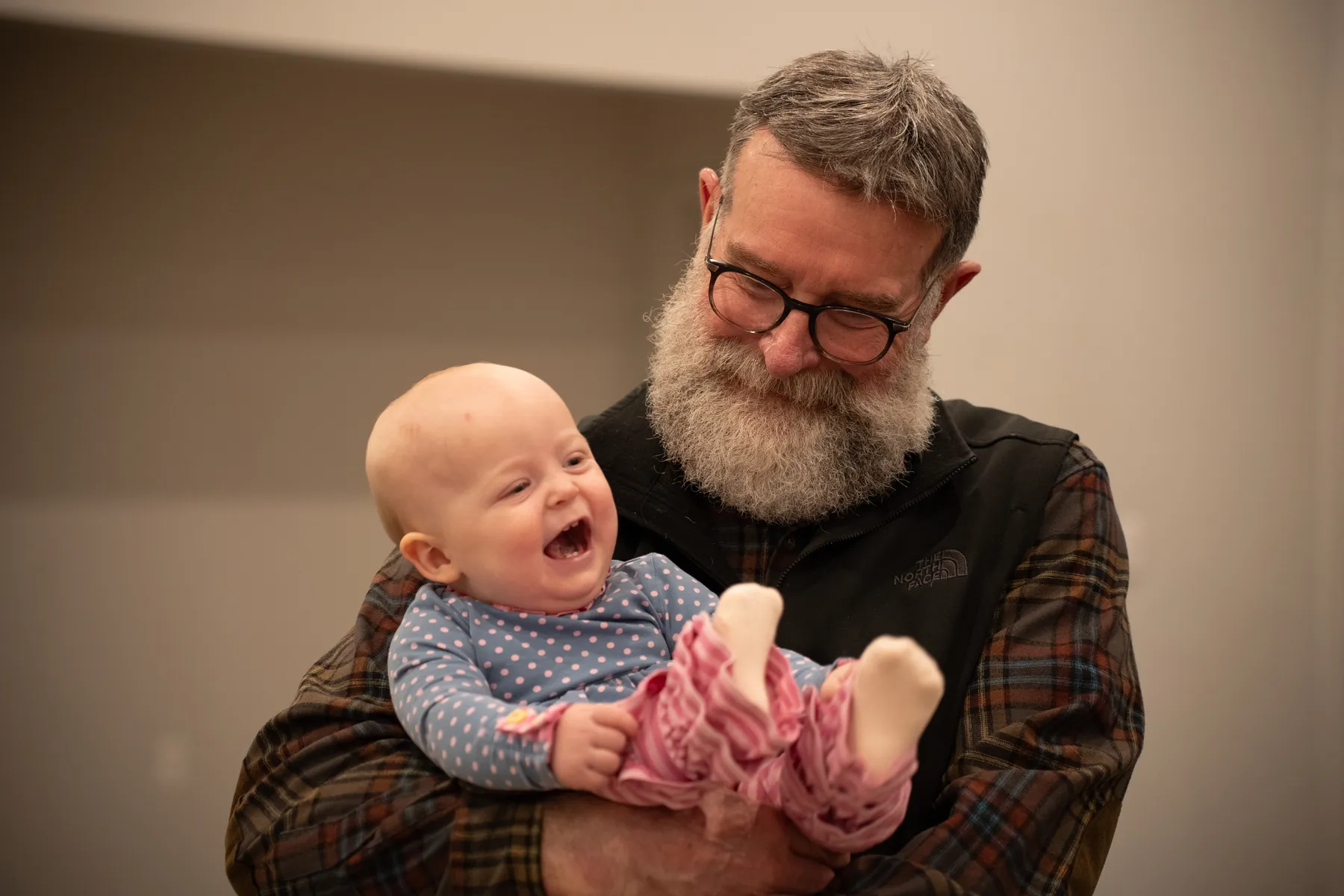 A baby laughing during a child dedication at Sun City Church