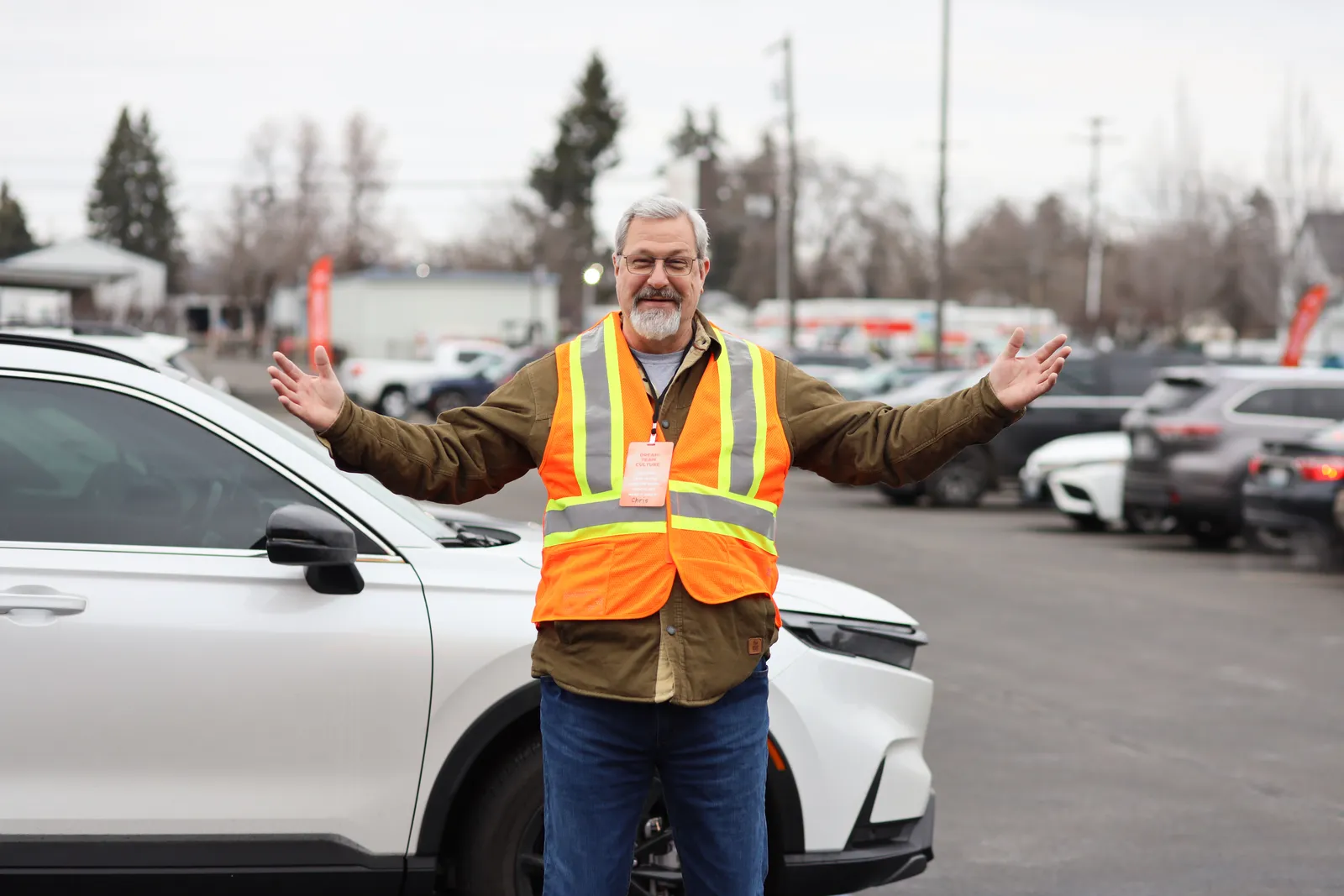 A parking team greeter welcoming everyone with open arms