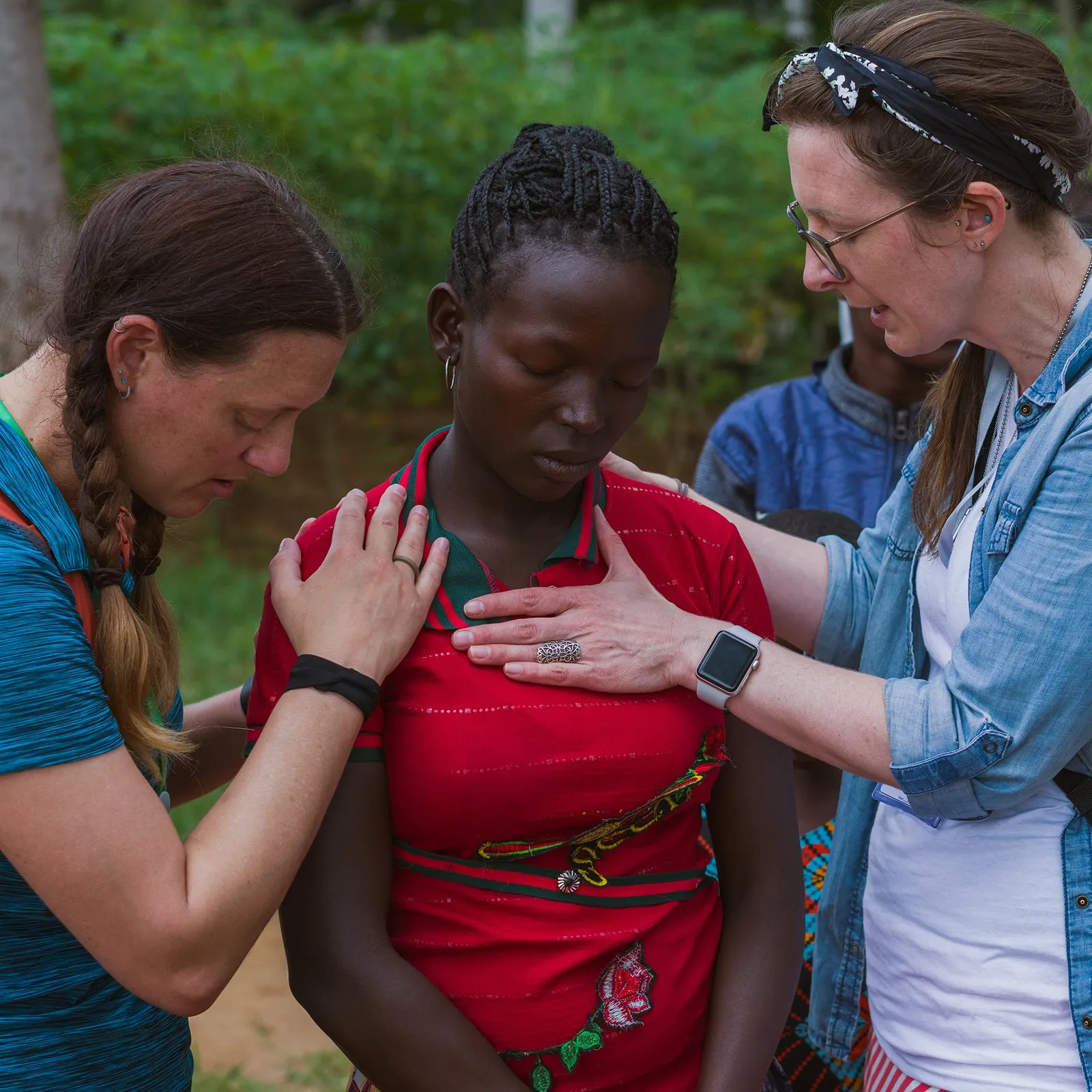 A Sun City mission team praying with believers in Tanzania